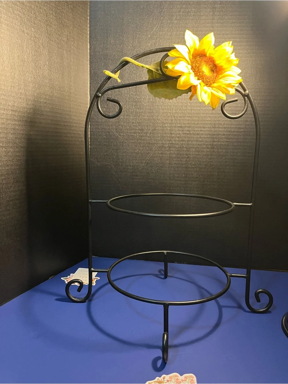 Black Two-Tier Metal Display Stand with Sunflower Accent